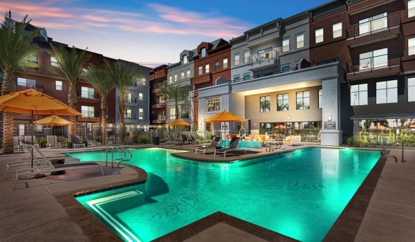 Swimming pool in a courtyard with lights glowing under the water