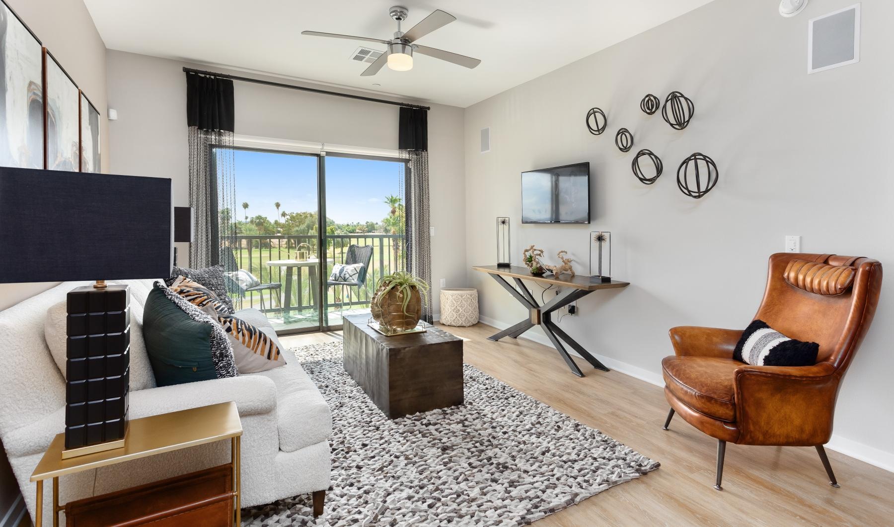 Beautiful living areas to match your lifestyle Modern living room with large sliding glass doors leading to balcony at Summit at San Marcos apartments in Chandler